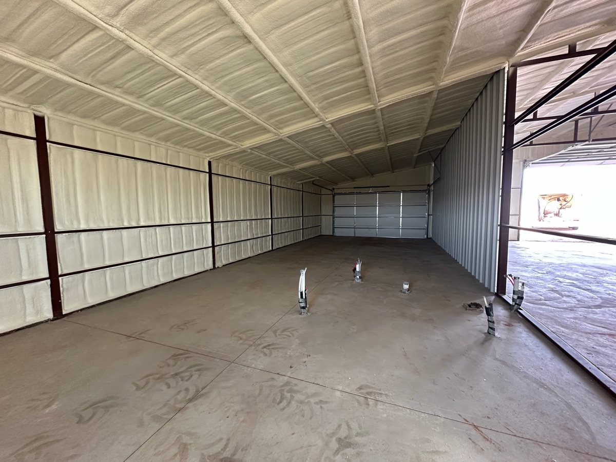 Spray foam insulation in a horse barn with insulated stalls for livestock comfort and temperature control.