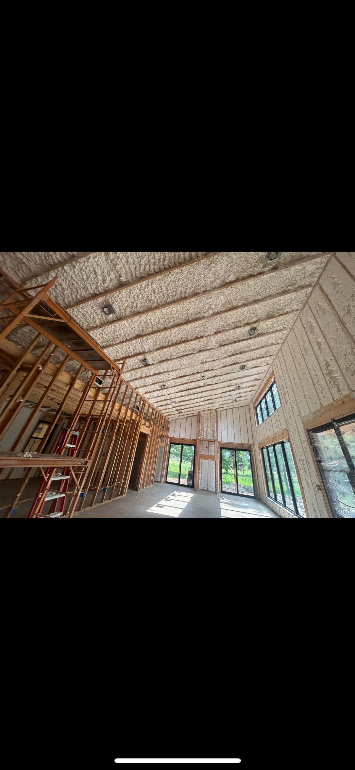 Open cell spray foam applied to a luxury home cathedral ceiling during new construction in Oklahoma.