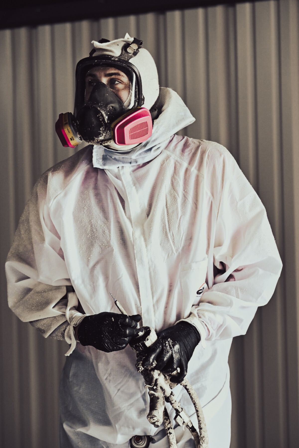 Spray foam insulation technician in full safety gear ready for application in Oklahoma