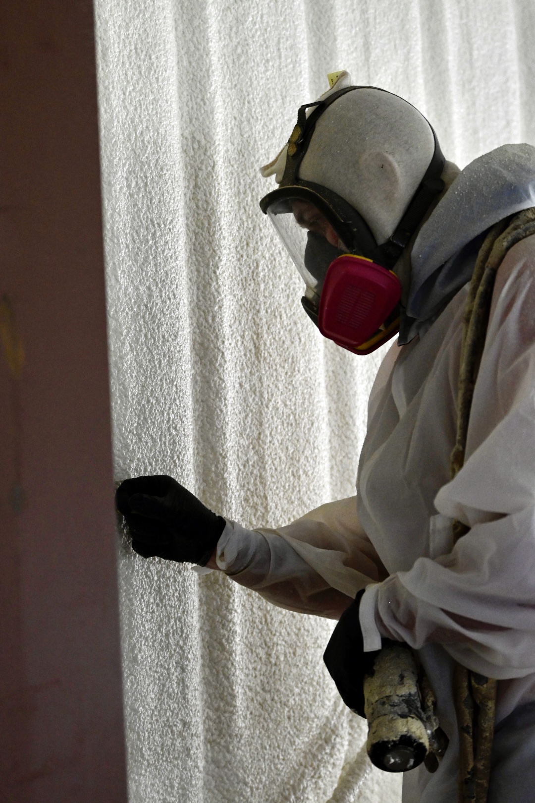 Detailed view of spray foam insulation being applied to a wall in Oklahoma — even coverage for maximum performance.